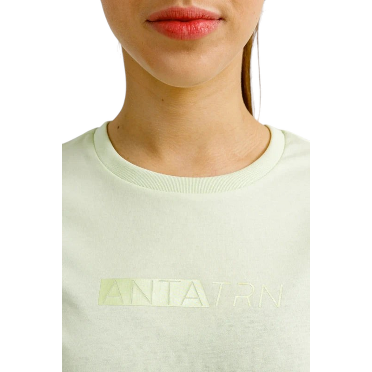 FRG ANTA green short sleeve cross training t-shirt with crew neck and subtle chest logo detail on a female model