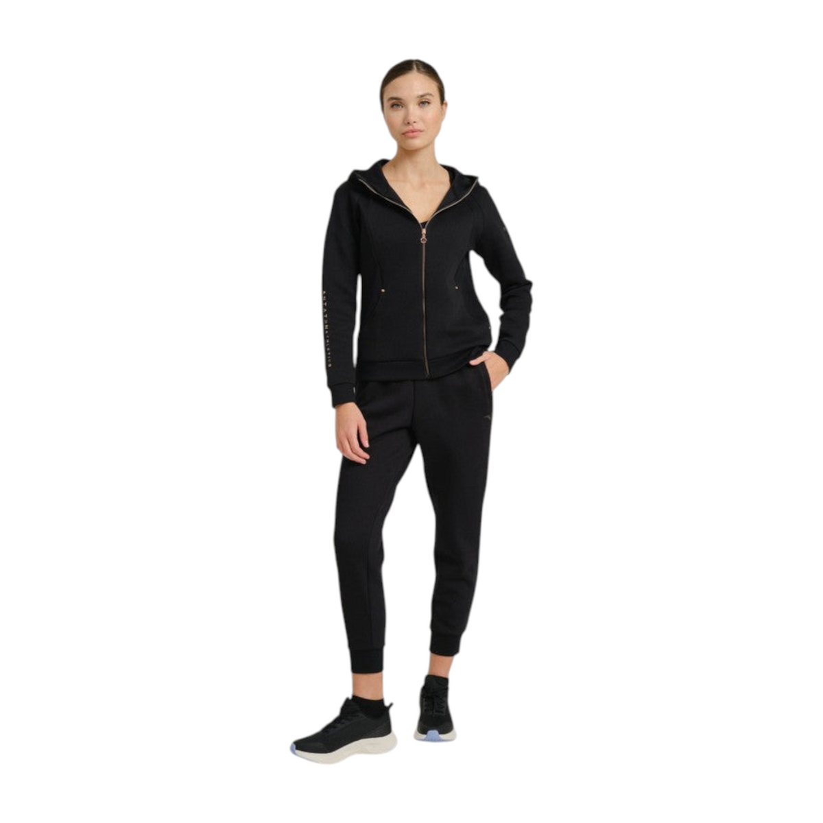 FRG model wearing ANTA black knit ankle pants and matching zip-up hoodie for a comfortable athletic look.