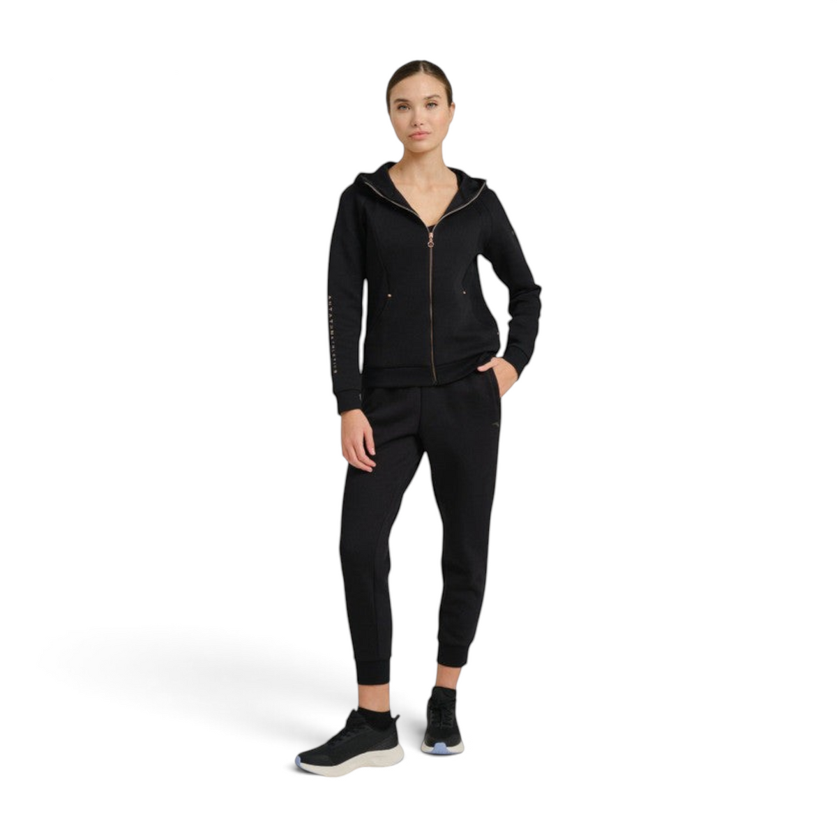 FRG model wearing ANTA black knit ankle pants and matching zip-up hoodie for a comfortable athletic look.
