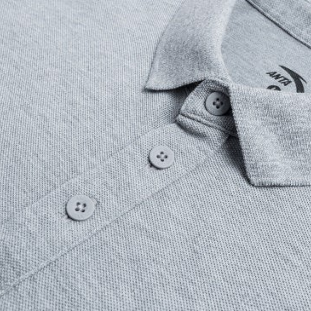 Close-up of a grey FRG SS POLO shirt featuring a classic collar, button placket, and textured pique fabric.