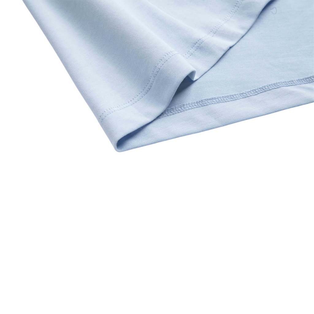 Close-up of the hem on a light blue FRG SS TEE showing the smooth cotton fabric and detailed stitching.
