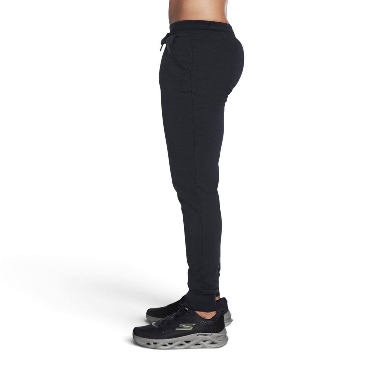 FRG SKECH-SWEATS Essential Jogger in black, side view on a model wearing athletic sneakers