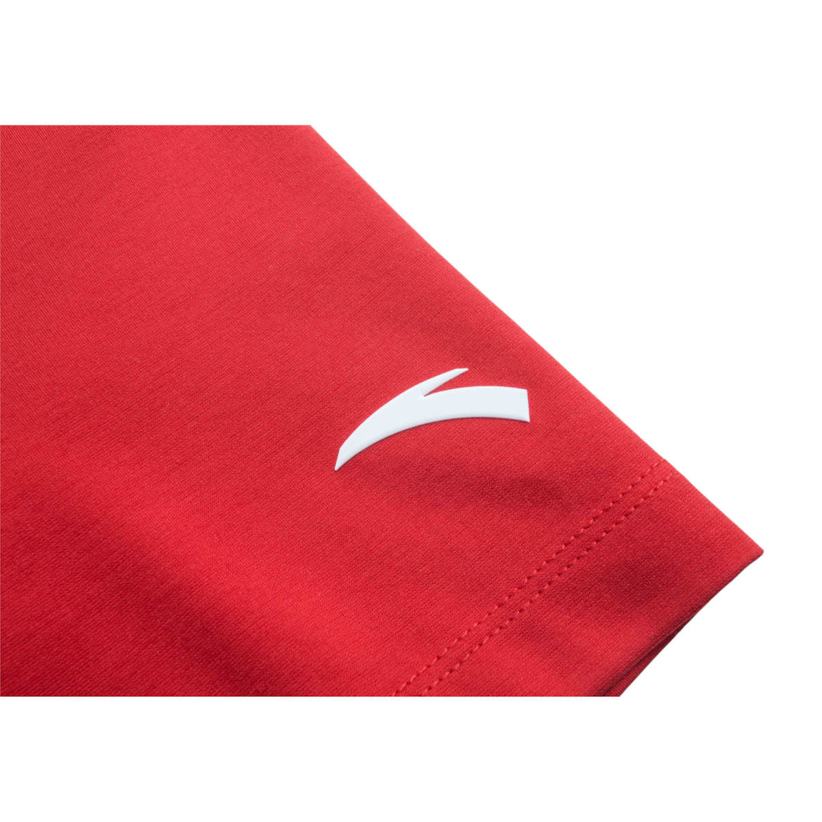 Close-up of a red FRG short sleeve t-shirt featuring a white logo detail on the sleeve