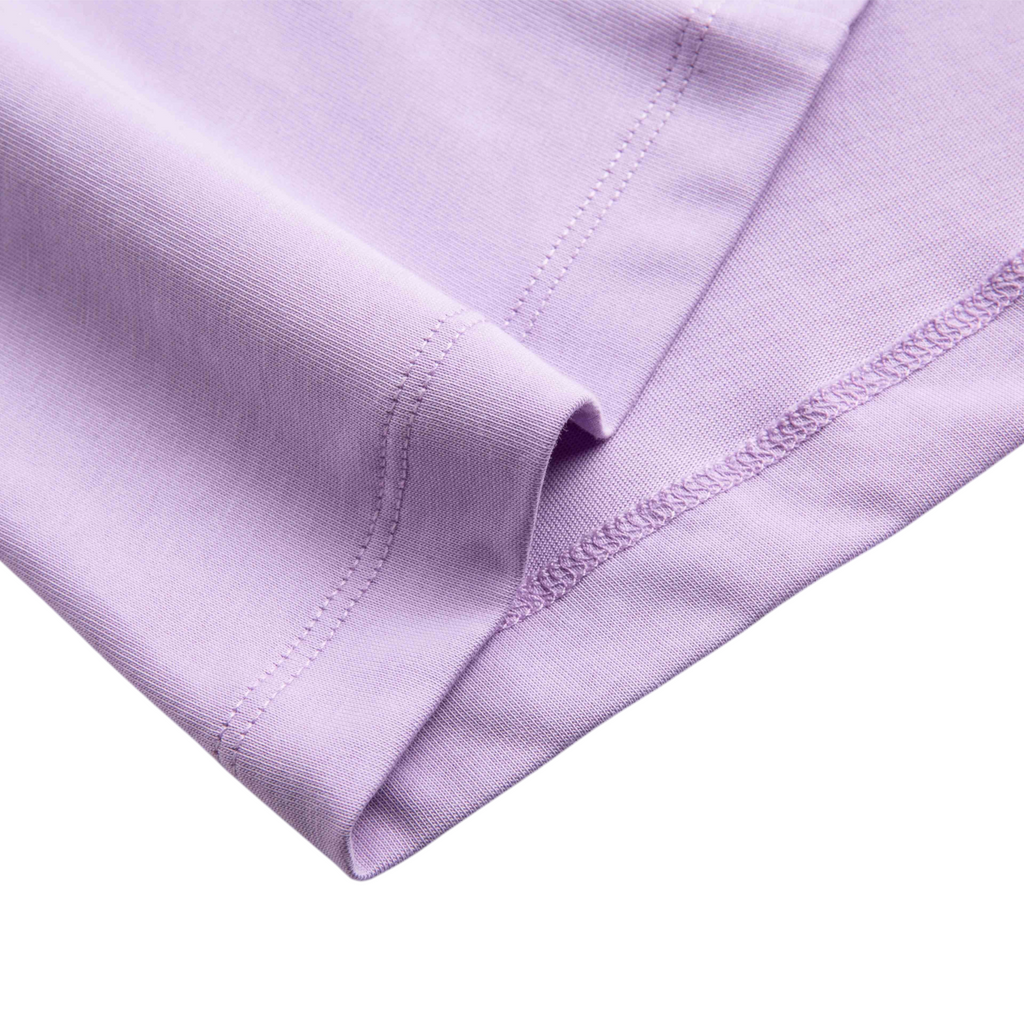 Close-up of the hem of a light purple FRG SS TEE showing smooth cotton fabric and detailed stitching.
