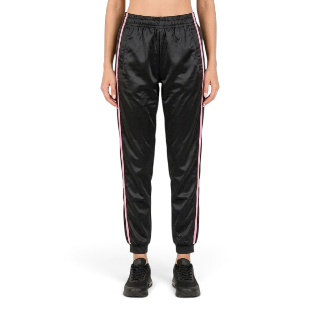 FRG ANTA black woven track pants with pink side stripes, featuring an elastic waistband and cuffed ankles.