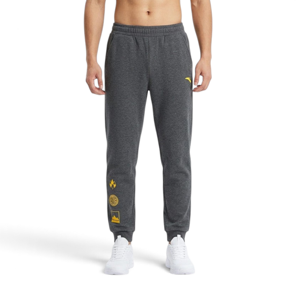 FRG ANTA outdoor knit track pants in heather grey with yellow graphic details and elastic cuffs on a model